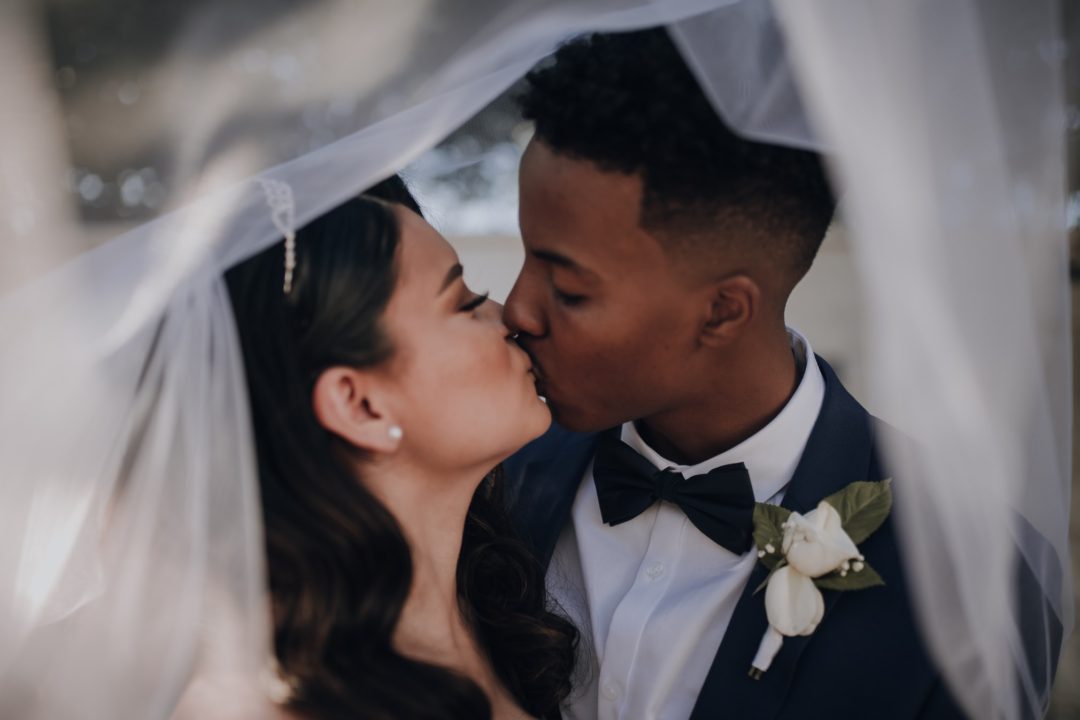 man kissing womans forehead